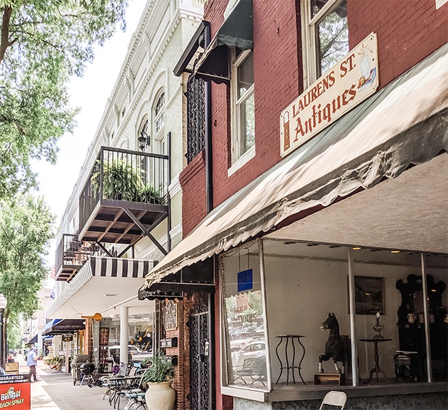 Storefronts and sidewalk cafés along Laurens Street in downtown Aiken