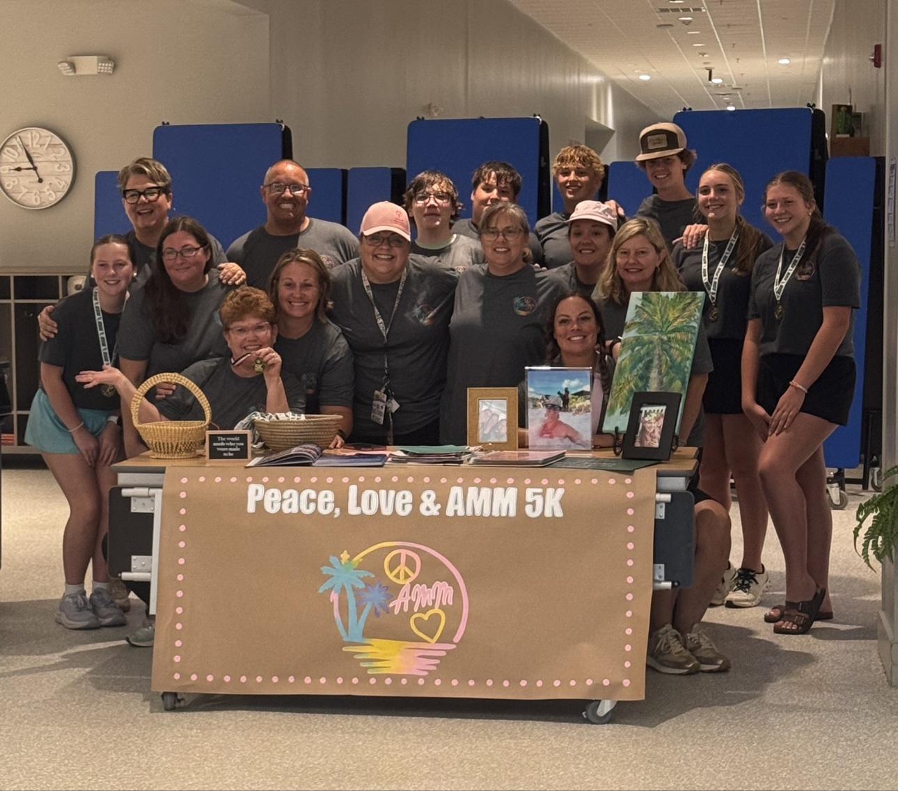 Runners, students, and volunteers gathered behind the Peace, Love & AMM 5K banner at the 2025 Peace, Love & Ann Marie McGhee 5K at Horse Creek Academy