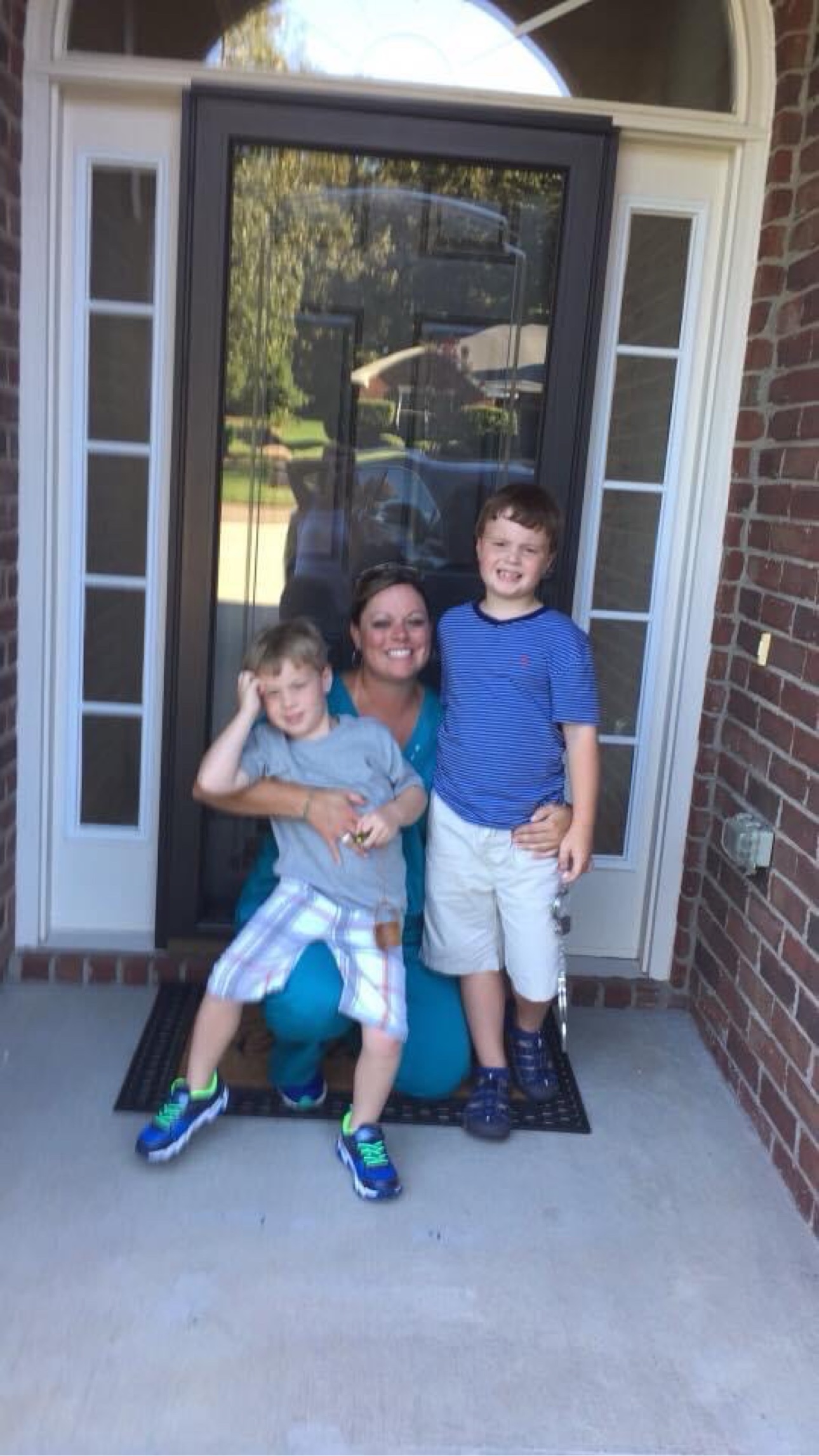 Tiffany McGhee with her young sons Davis and Brooks on the front porch of the first home she bought on her own, in 2016
